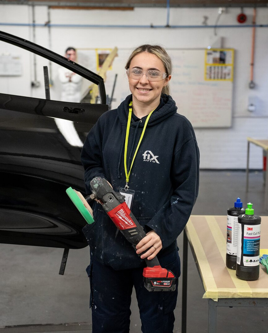 Apprentice polishing a car
