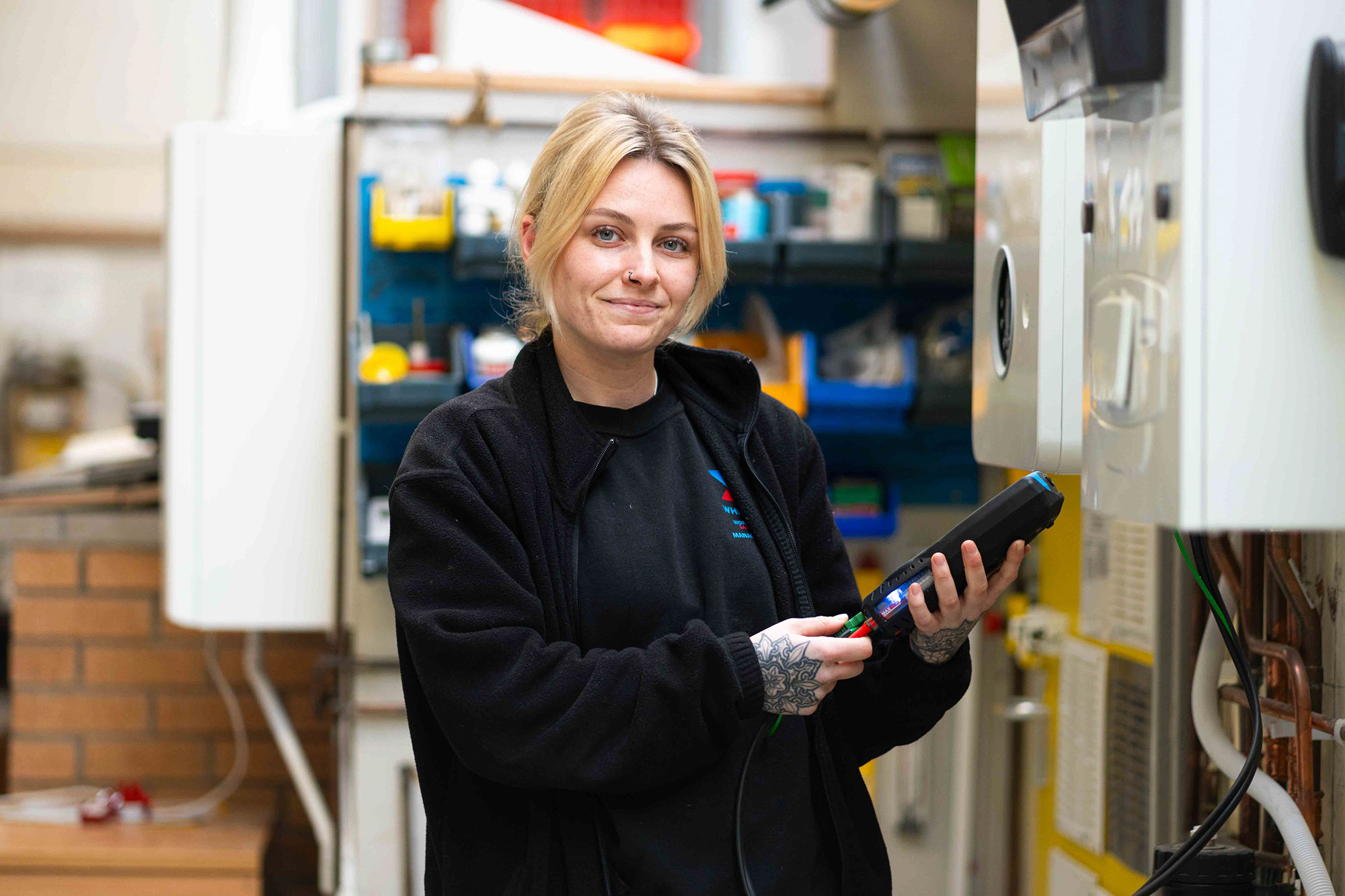 Female engineer holding mobile device