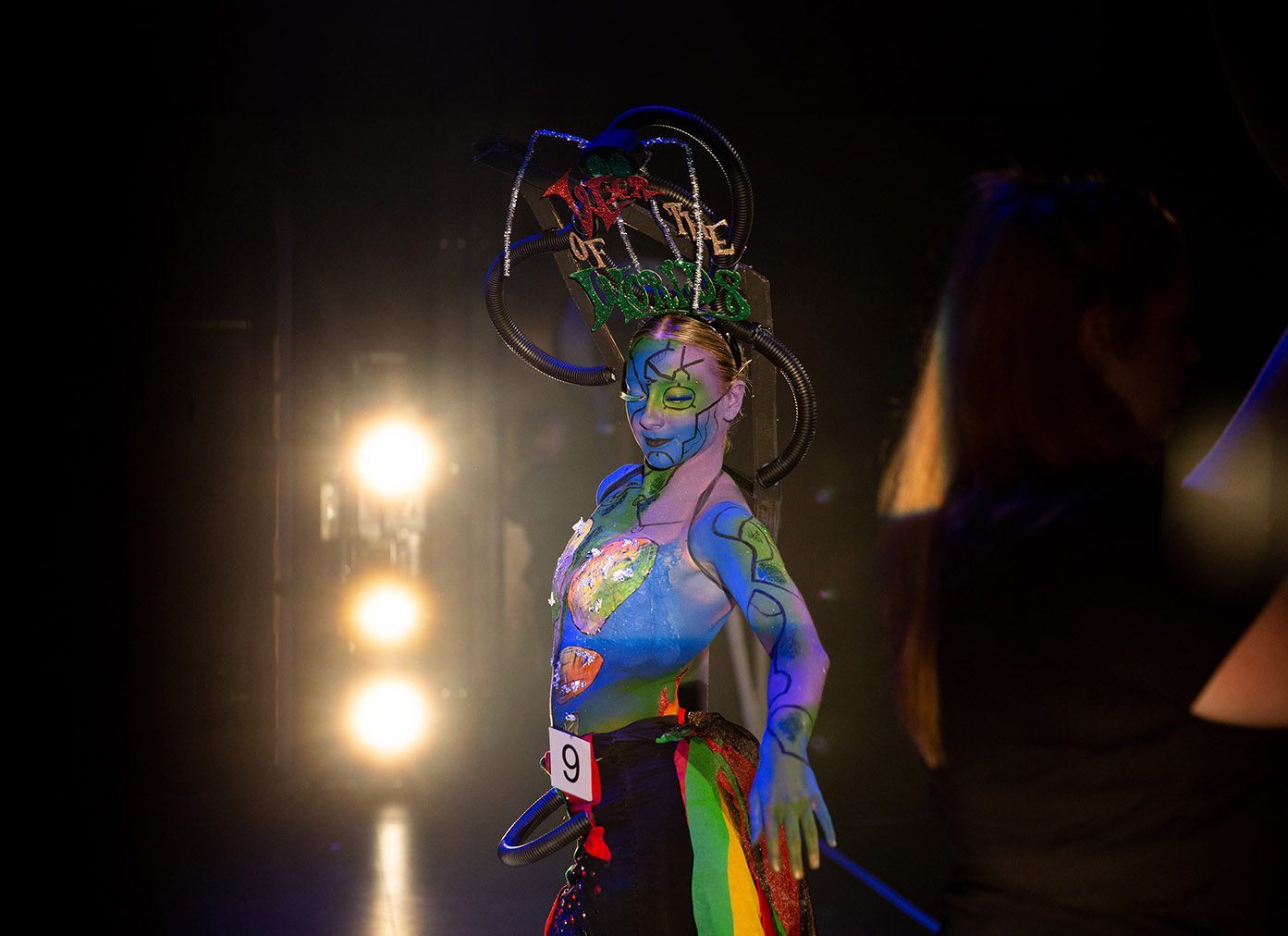 Theatrical makeup student on stage at Body Paint Expo