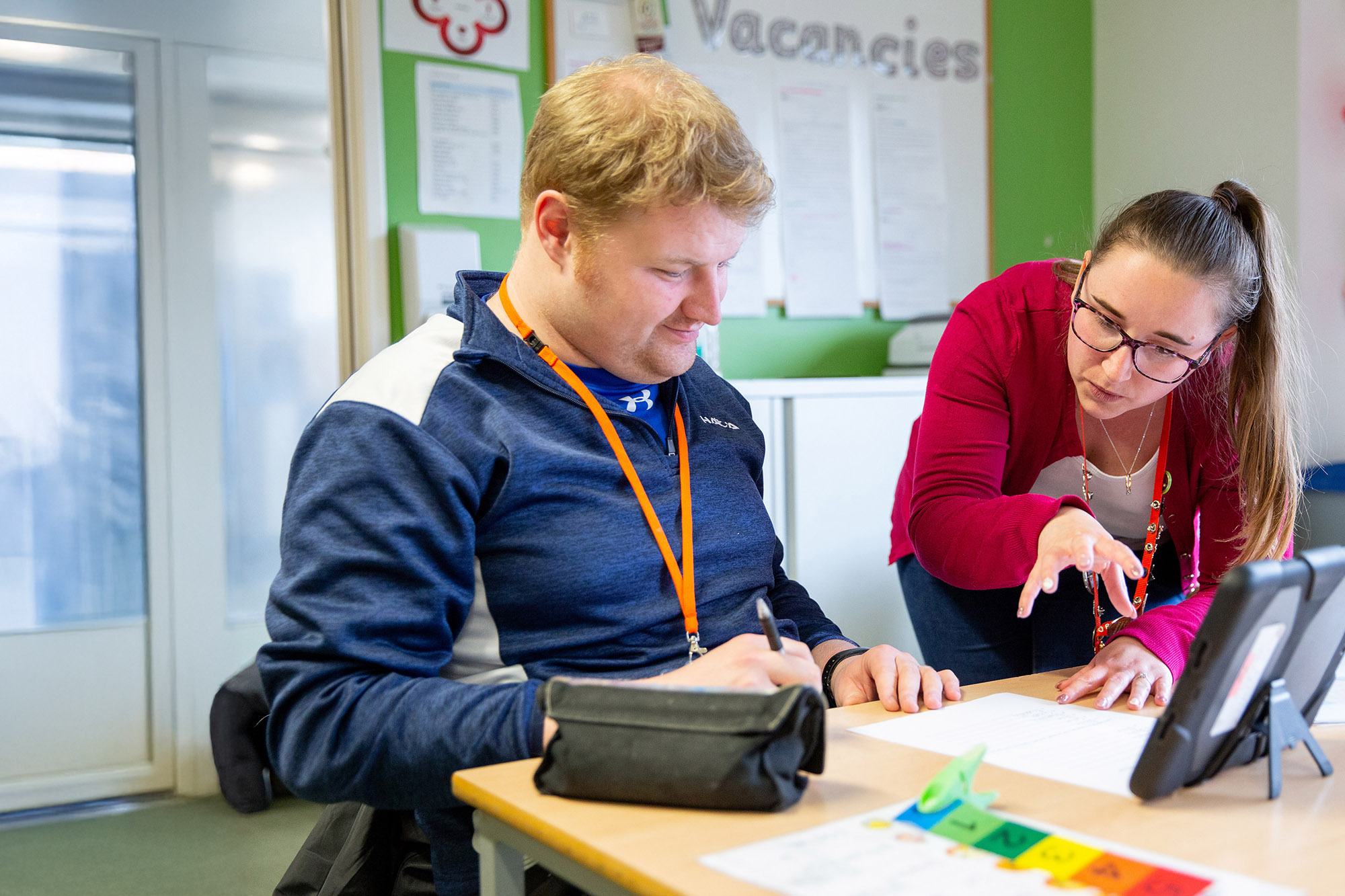 CG Support worker helping a learner.