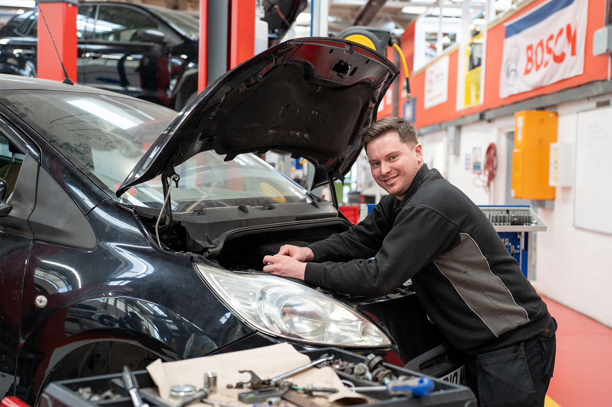 Automotive student working on car
