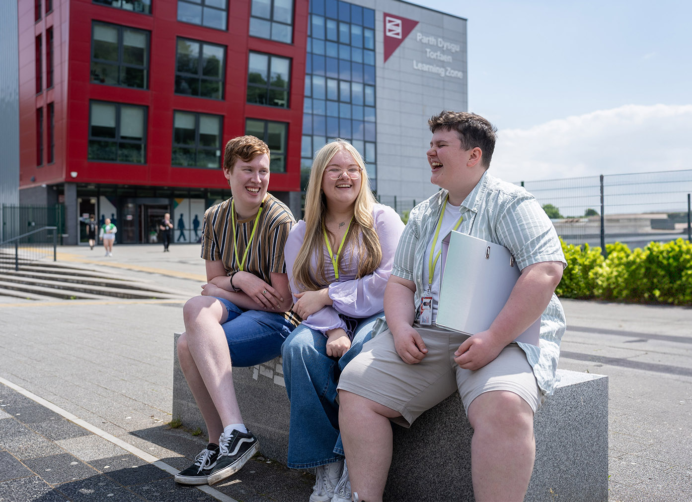 Three students chatting outside Torfaen Learning Zone