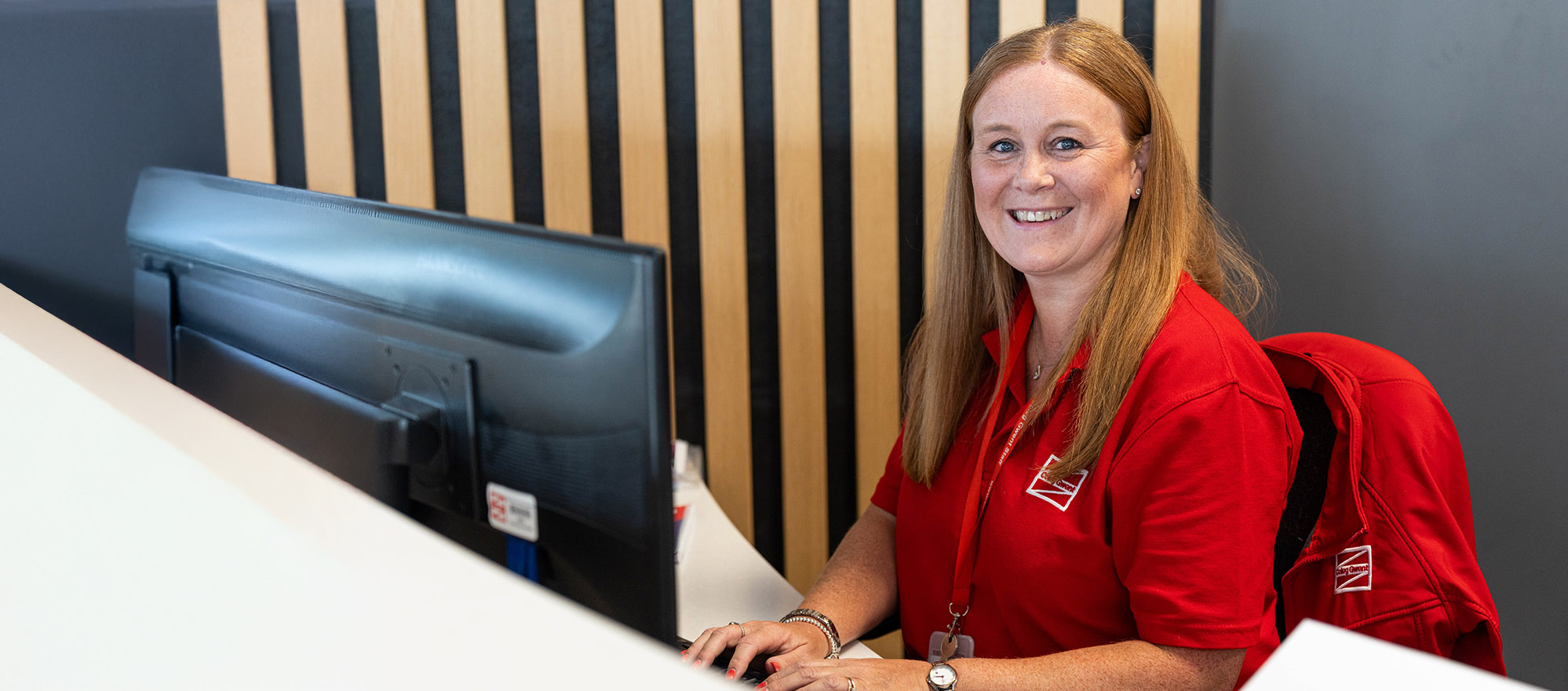Happy reception staff at computer