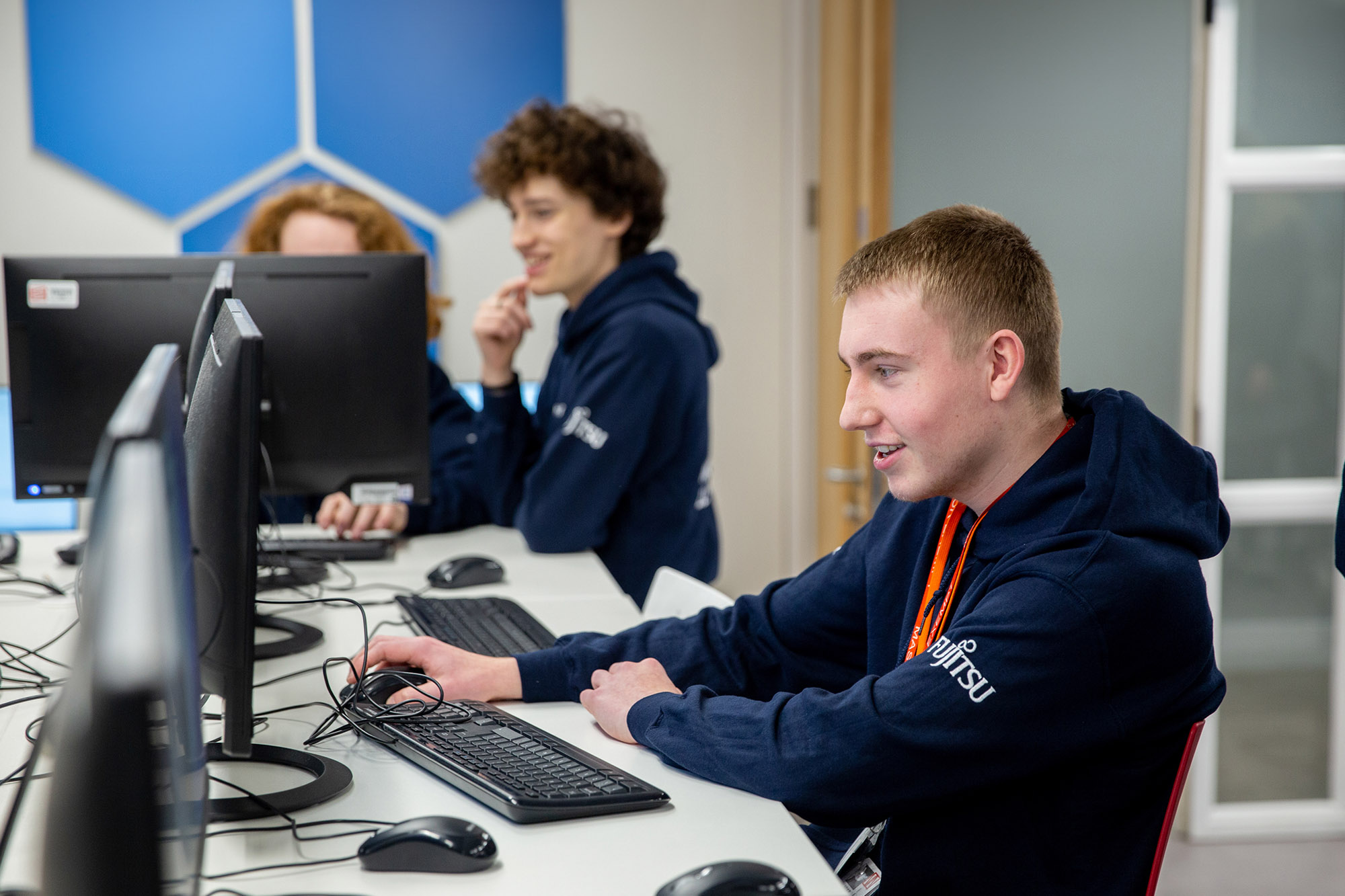 Student at computer holding mouse