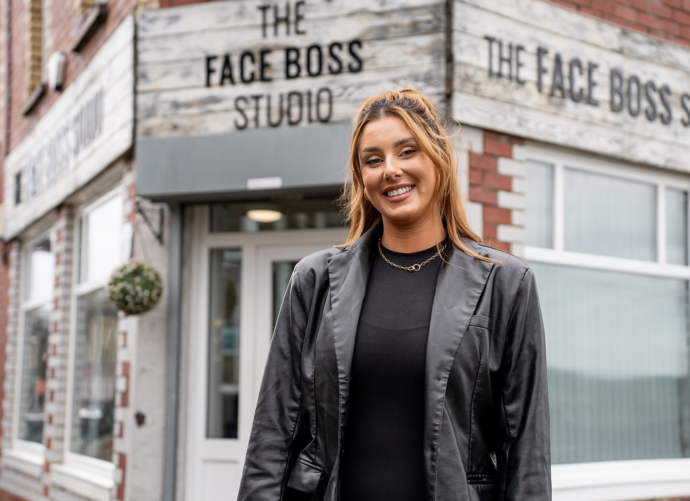 Alumni standing outside of their business