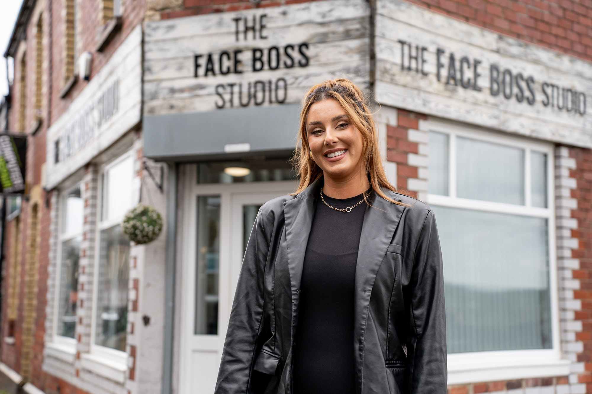 Alumni standing outside of their business