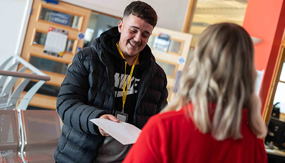 staff and student smiling