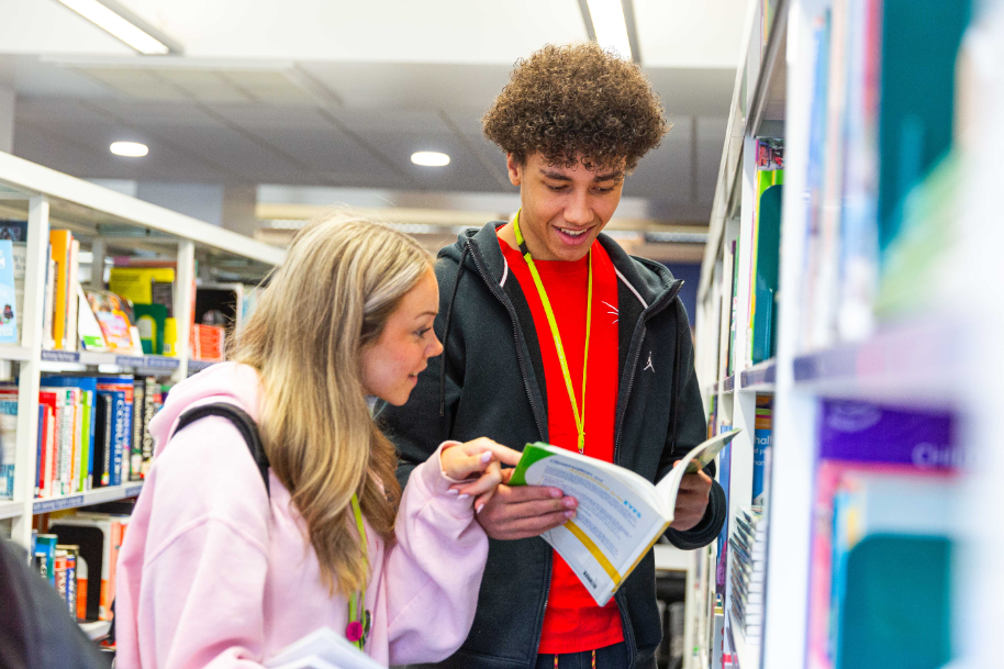 Students in Crosskeys library looking at book