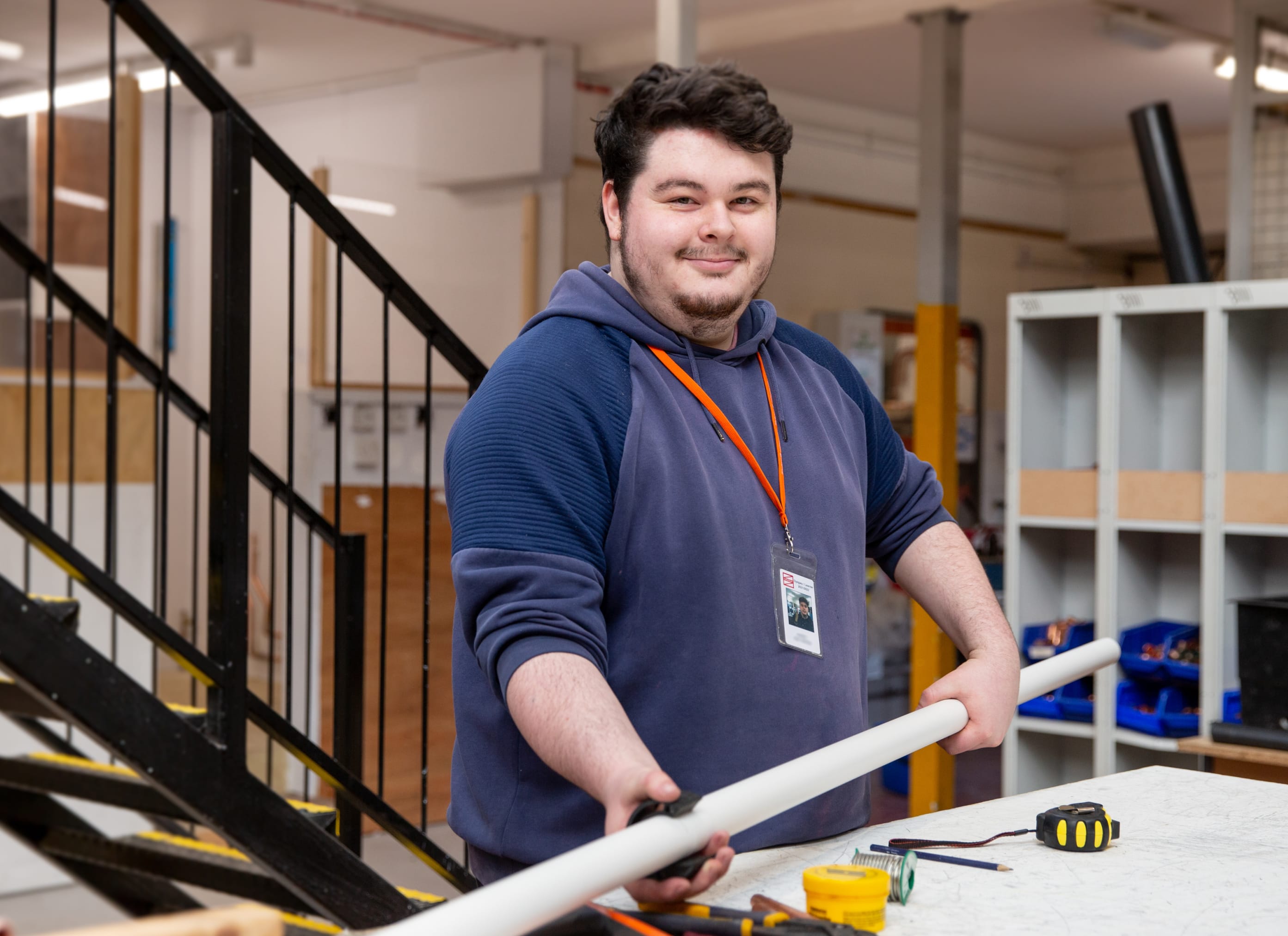 Plumbing student with a pipe