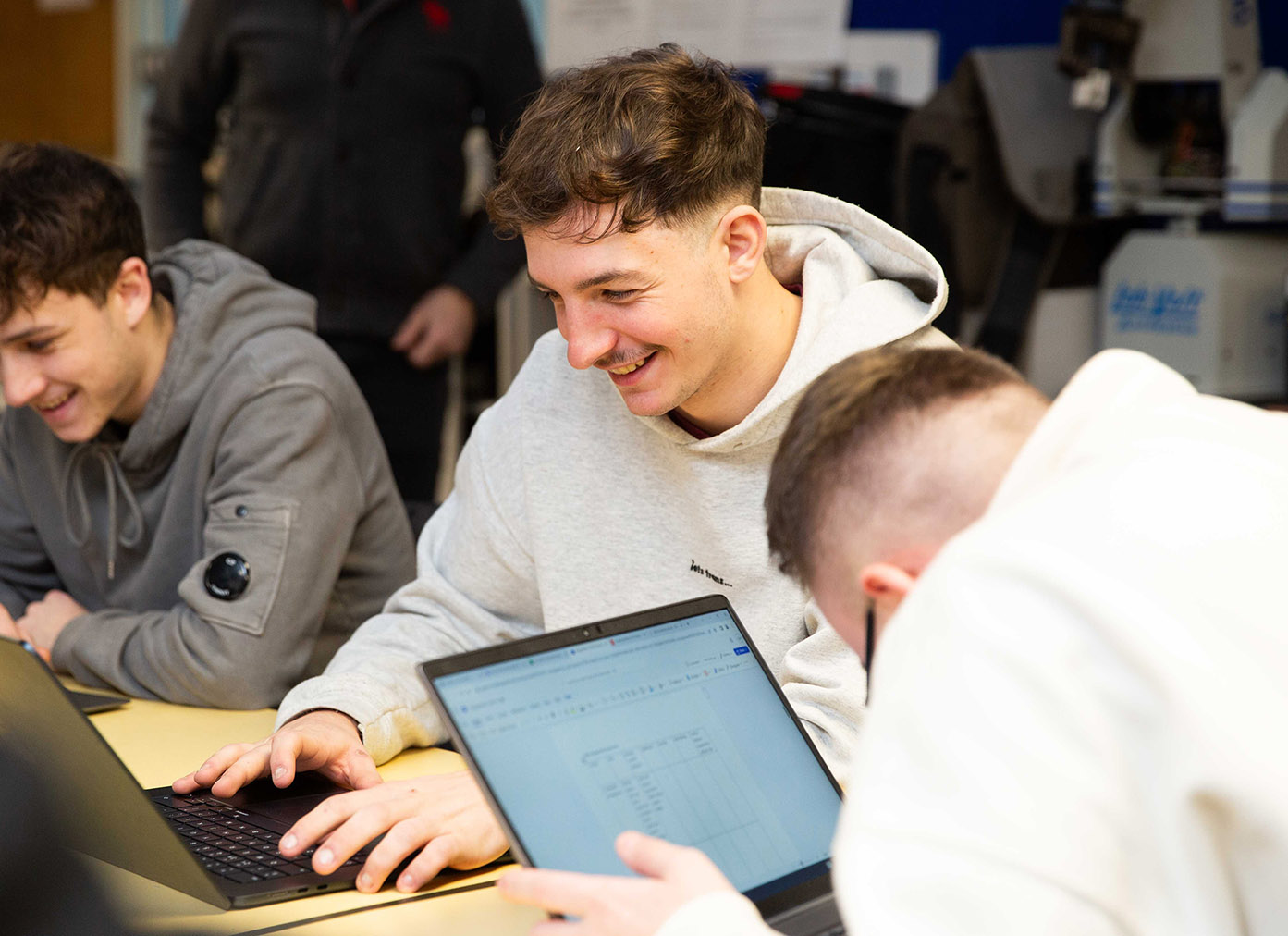 CG learners laughing together in a group.