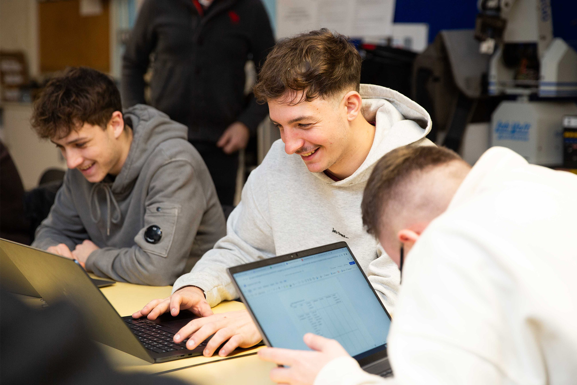 CG learners laughing together in a group.