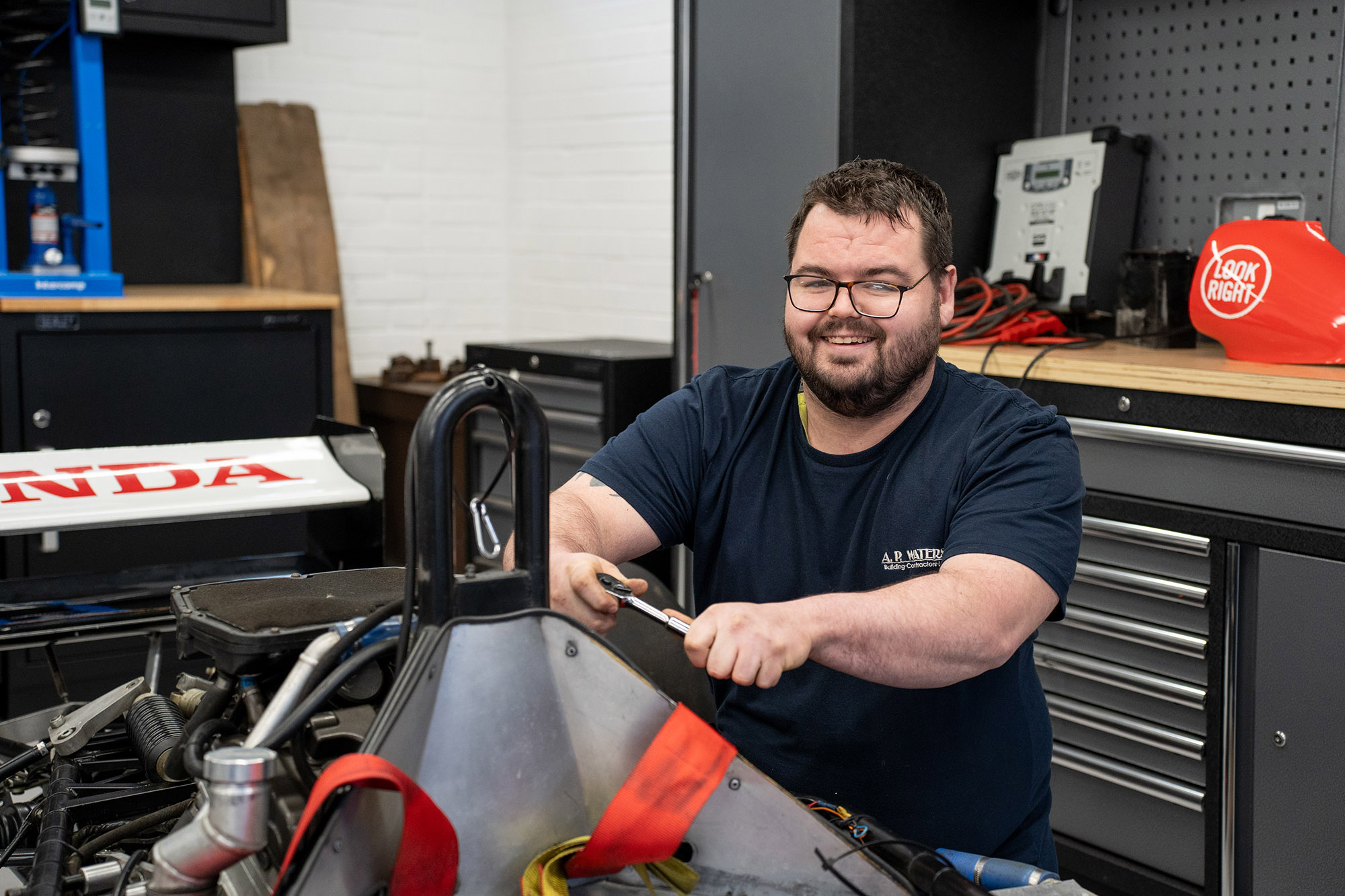 Apprentice working on a race car