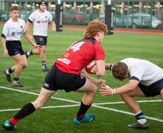 Dragons junior rugby academy player running with ball