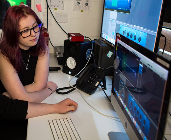 Students in media editing suite