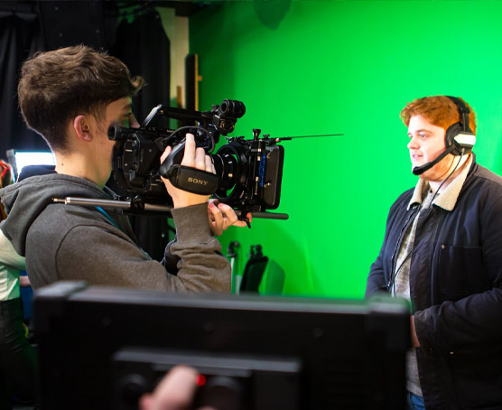 Students filming in studio with green screen at Crosskeys