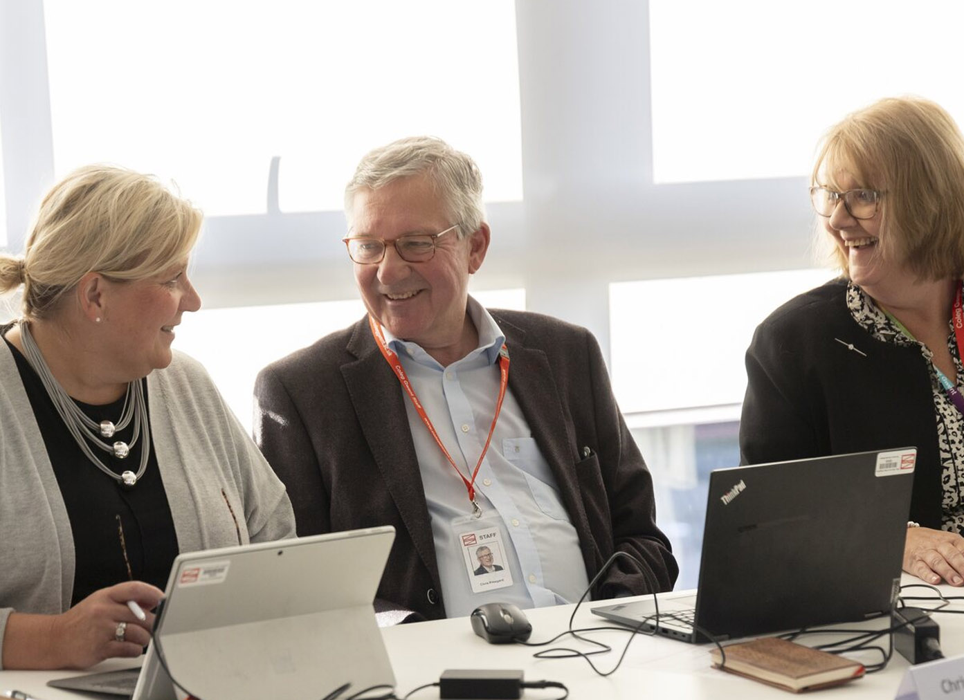 Governors using laptops in a meeting