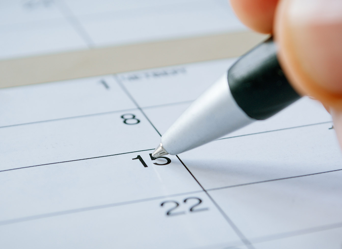 Pen pointing to a calendar date