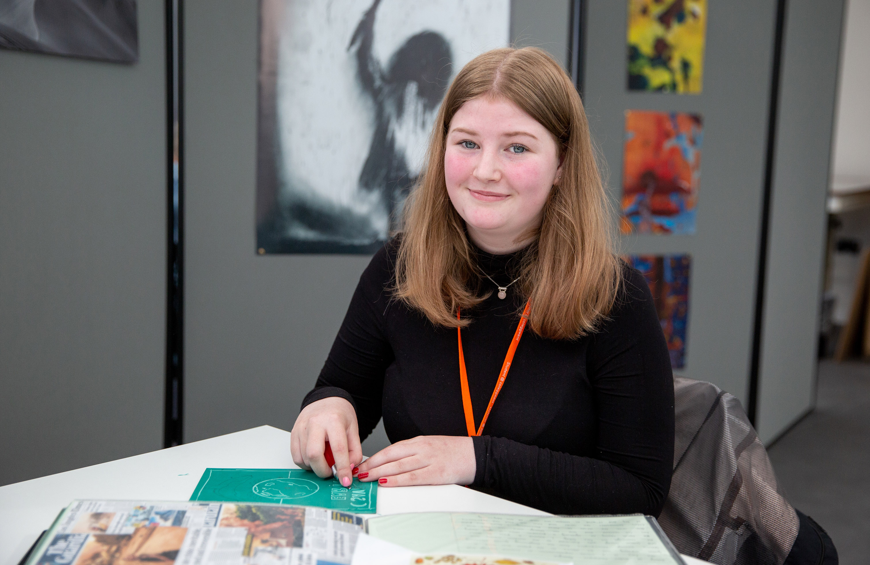 Art student smiling with work