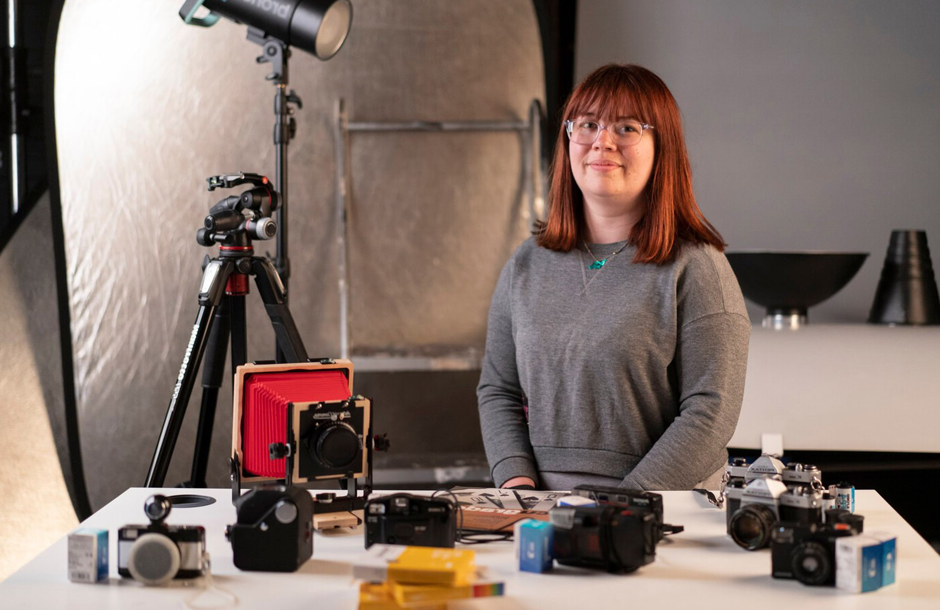 Photography student sitting with camera gear