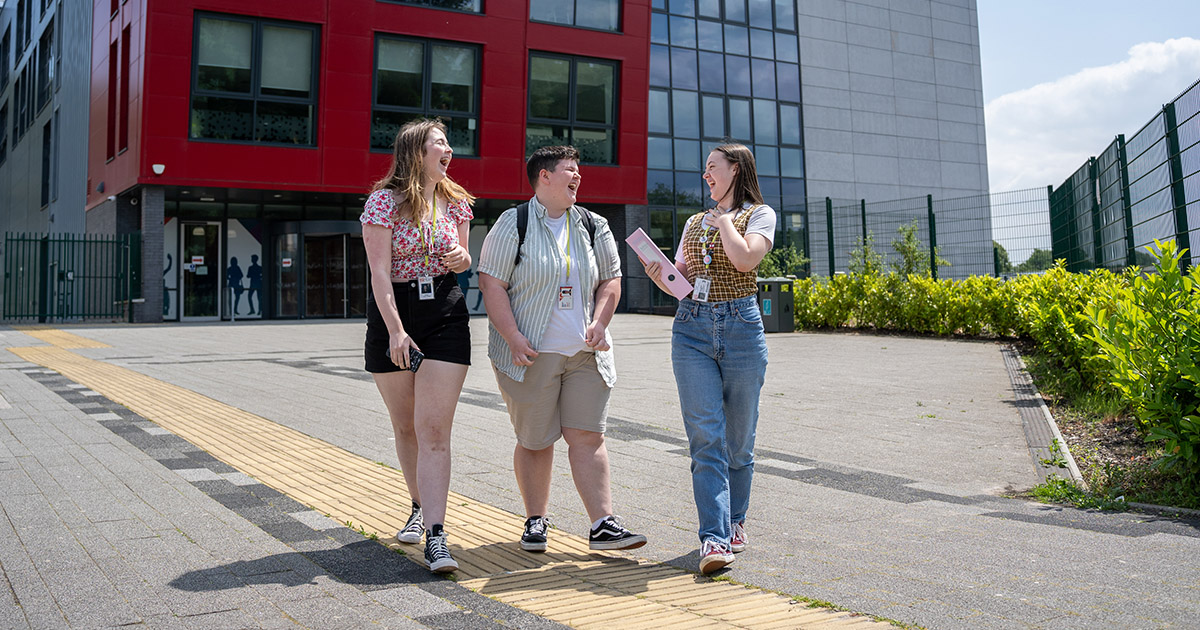 Students walking and talking outside TLZ campus