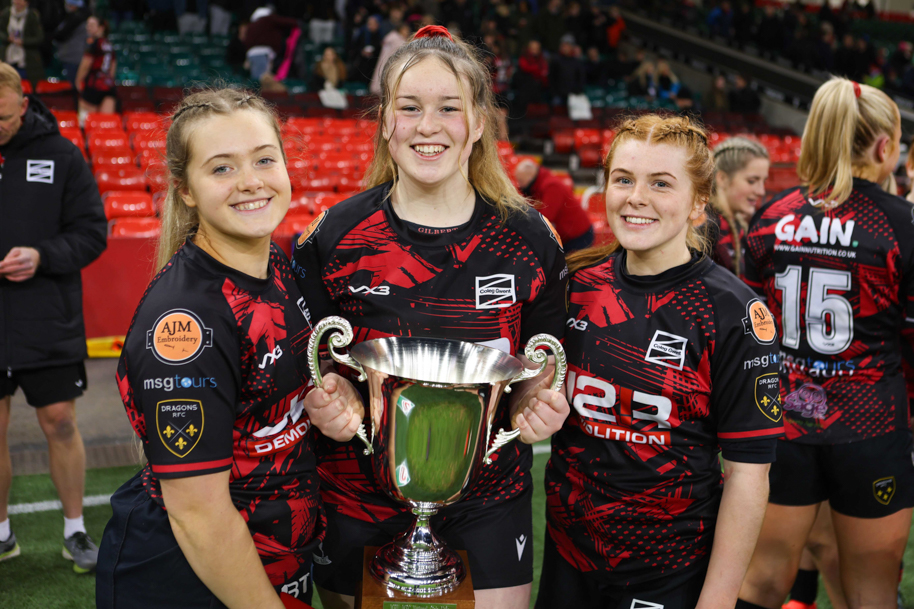 Girls holding rugby trophy