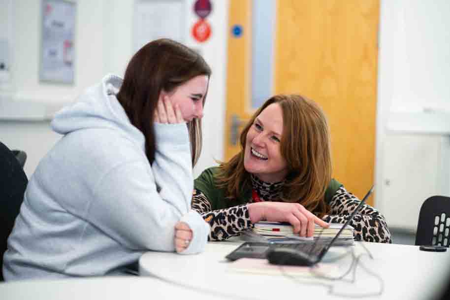 Tutor and student laughing