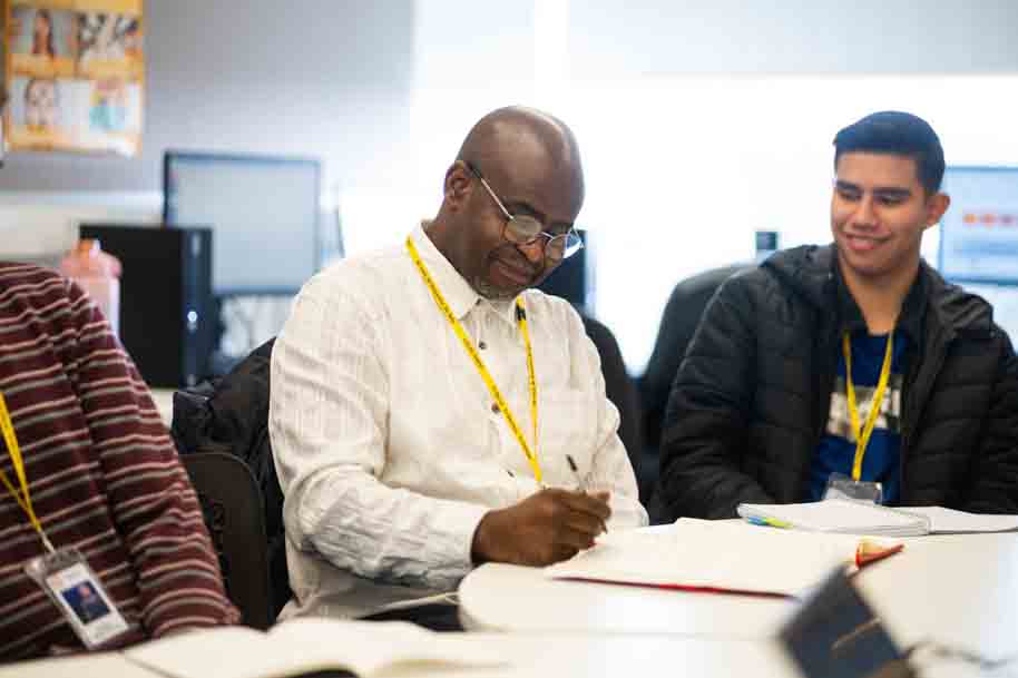 Mature student working in classroom