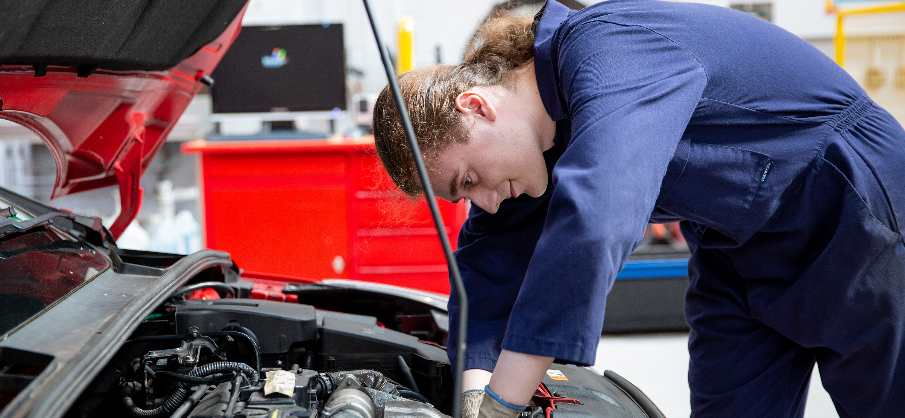 Automotive student fixing car