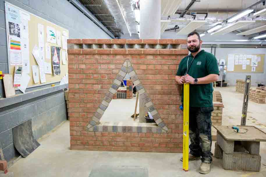 Mature student against brick wall