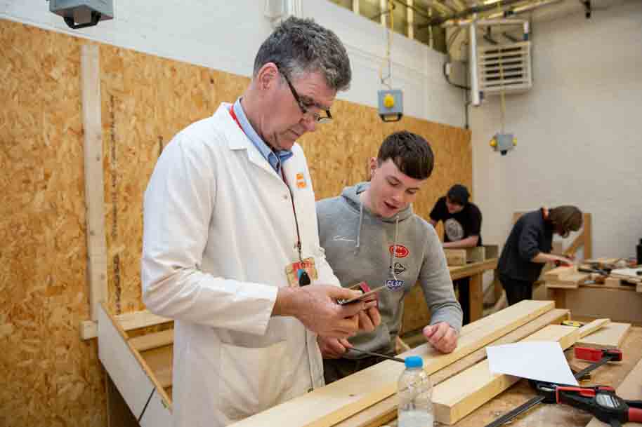 Tutor instructing how to use equipment