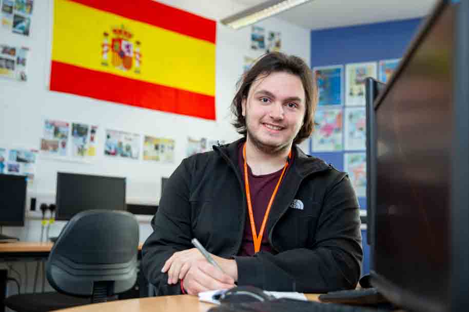 Student in classroom smiling