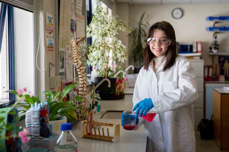 Student smiling in science lab