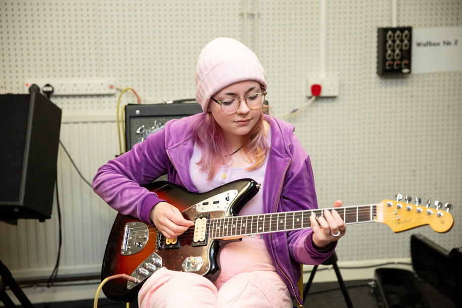 Student playing guitar