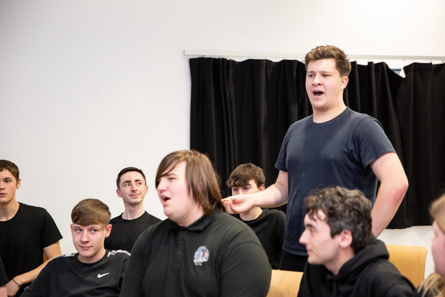 Student talking in front of class