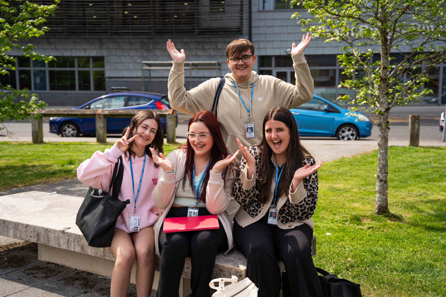 HE Students all laughing on bench