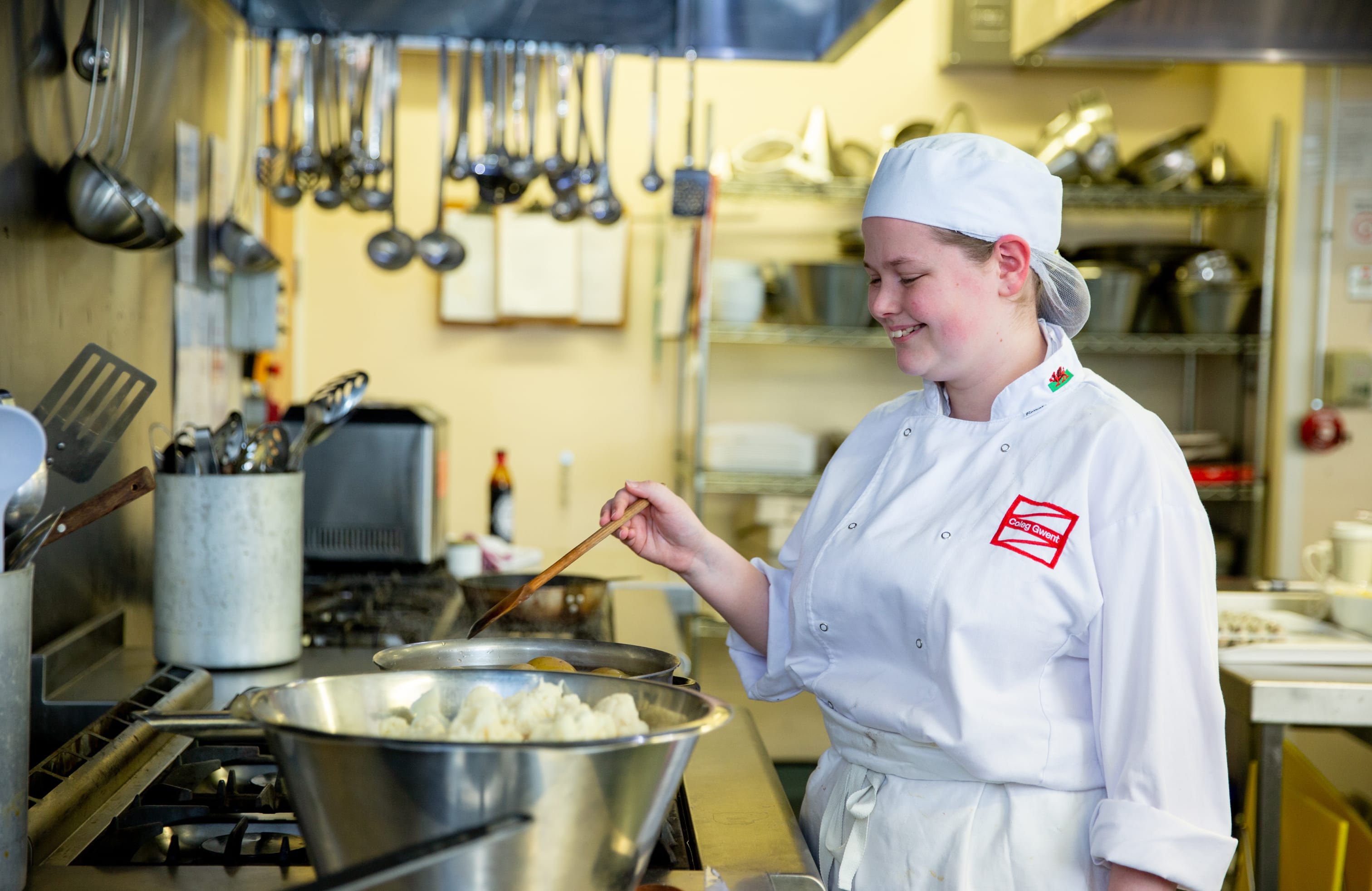 Catering student stirring a pot