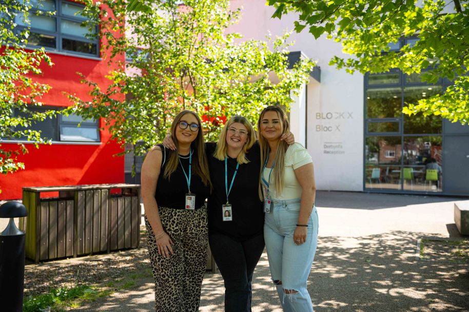 Students outside the crosskeys campus smiling