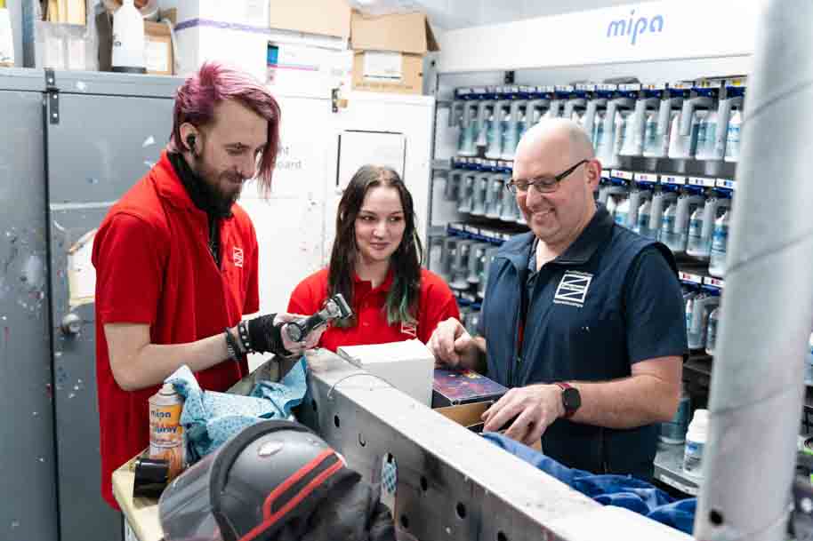 Tutor walking through students on Vehicle Body Spraying