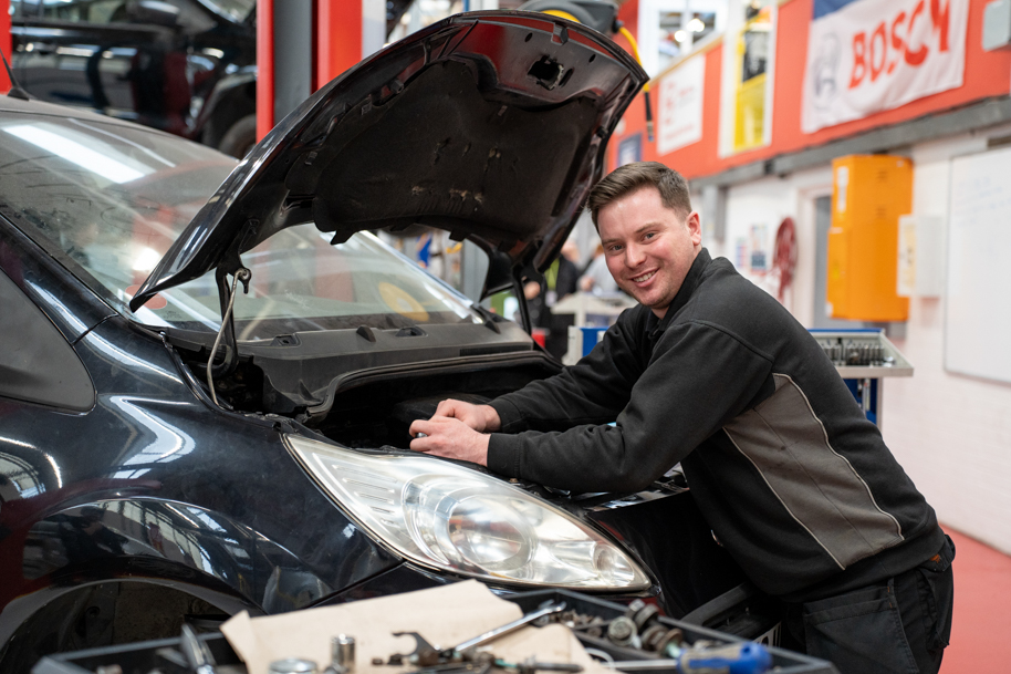 Student in vehicle repair