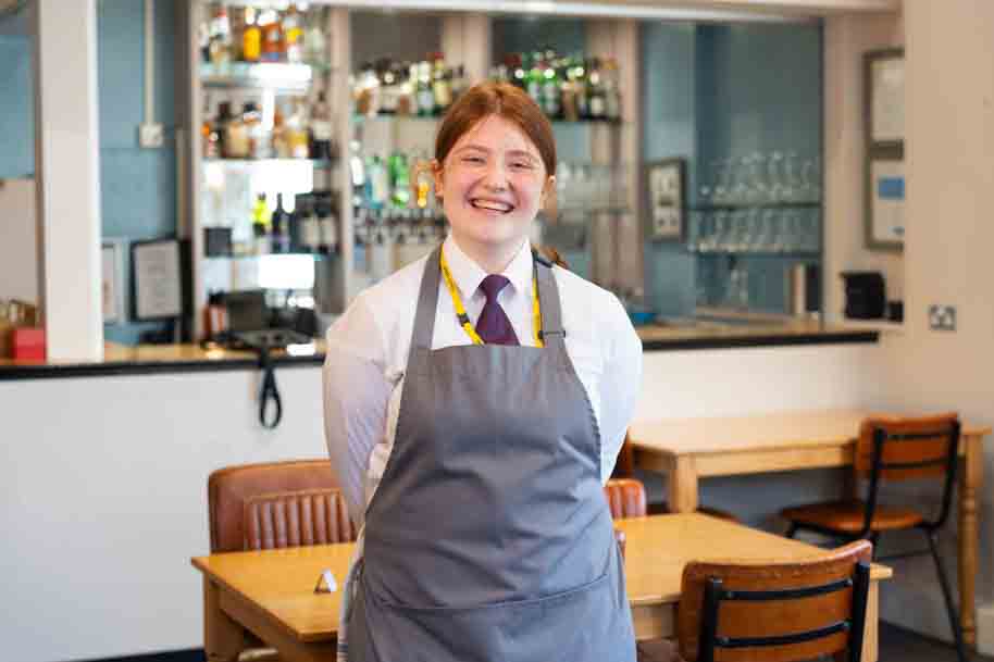 Hospitality student smiling in Morels restaurant