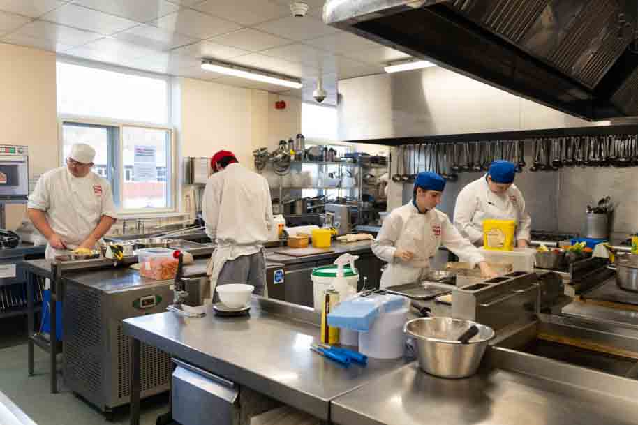 Catering students working together in the kitchen