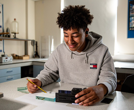 Young student doing science experiment in lab