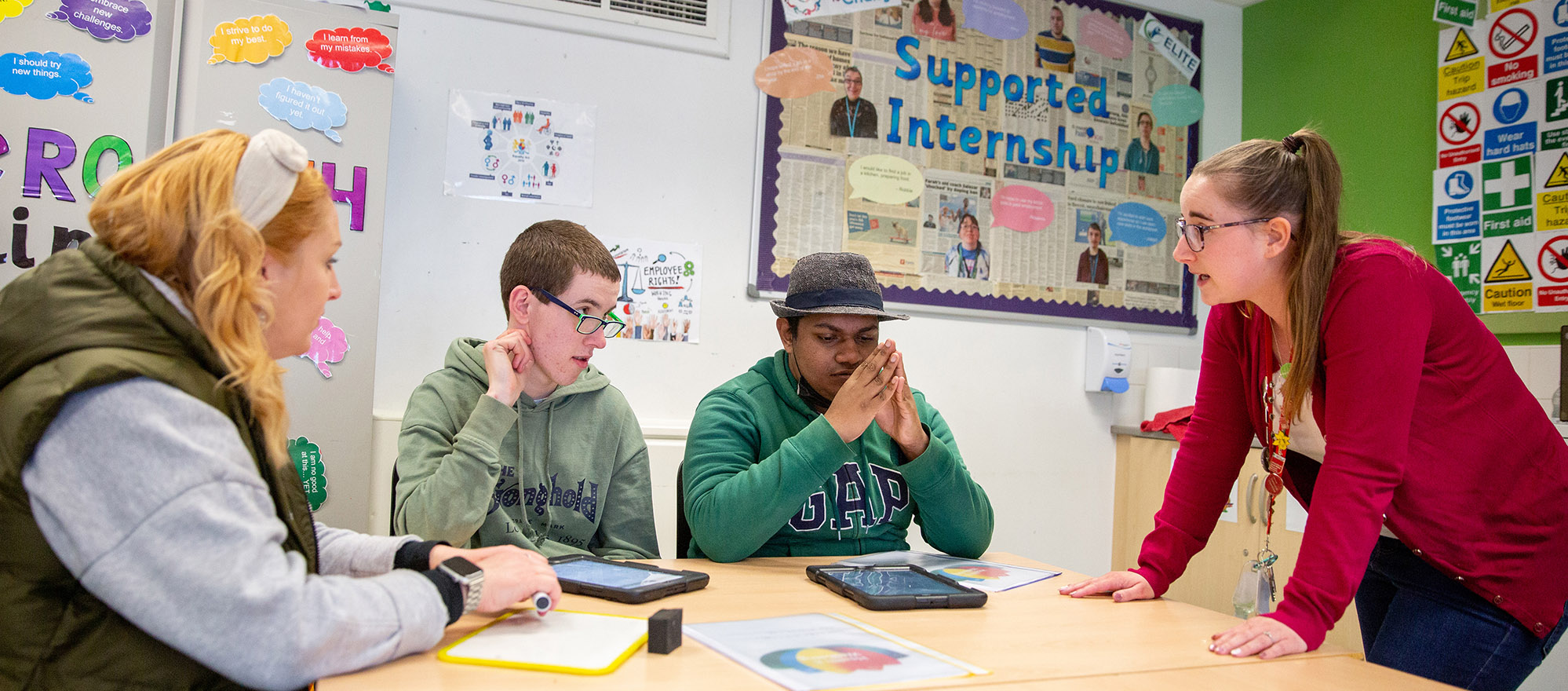 Tutor talking to students in the classroom
