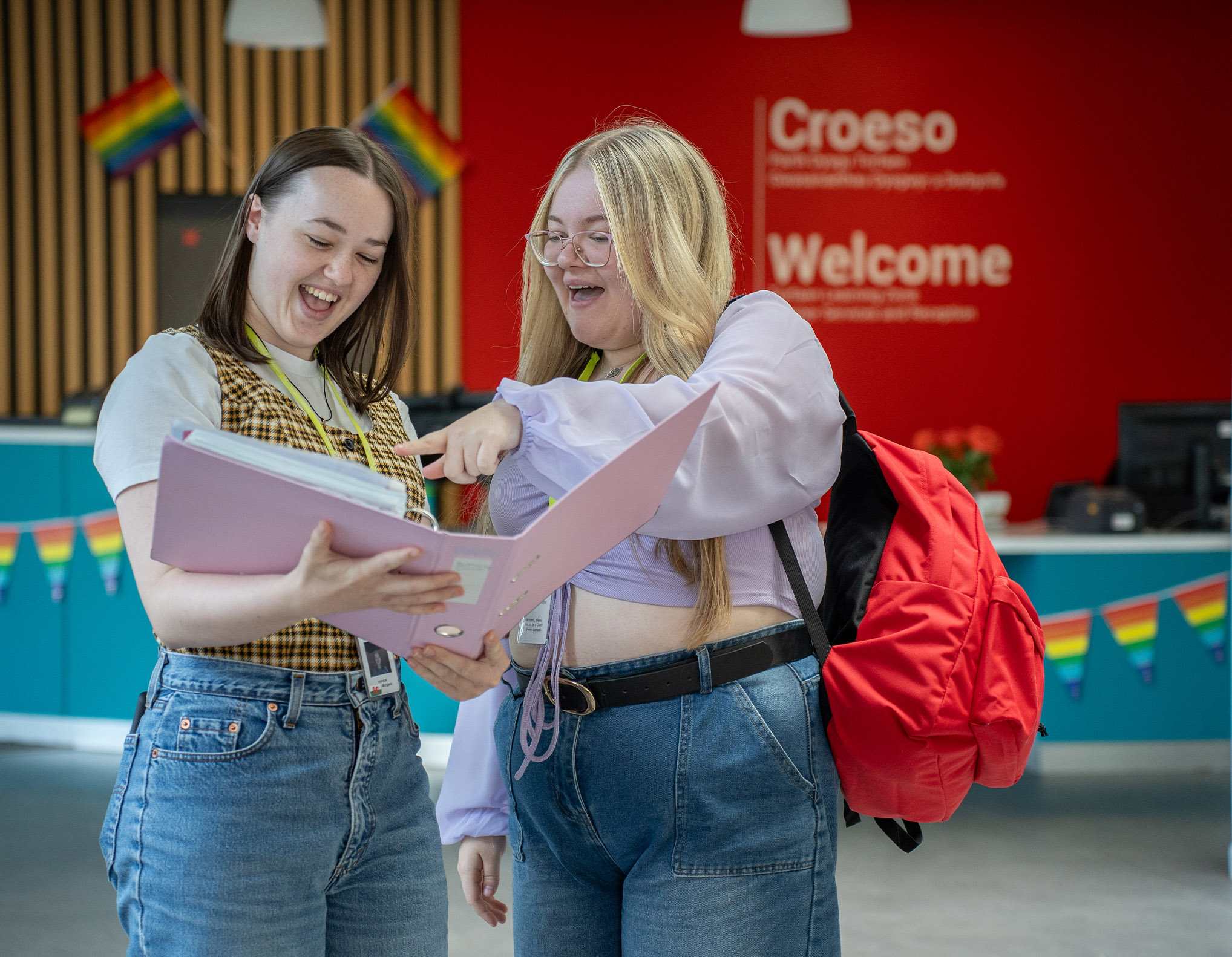 Students looking at a folder in TLZ reception