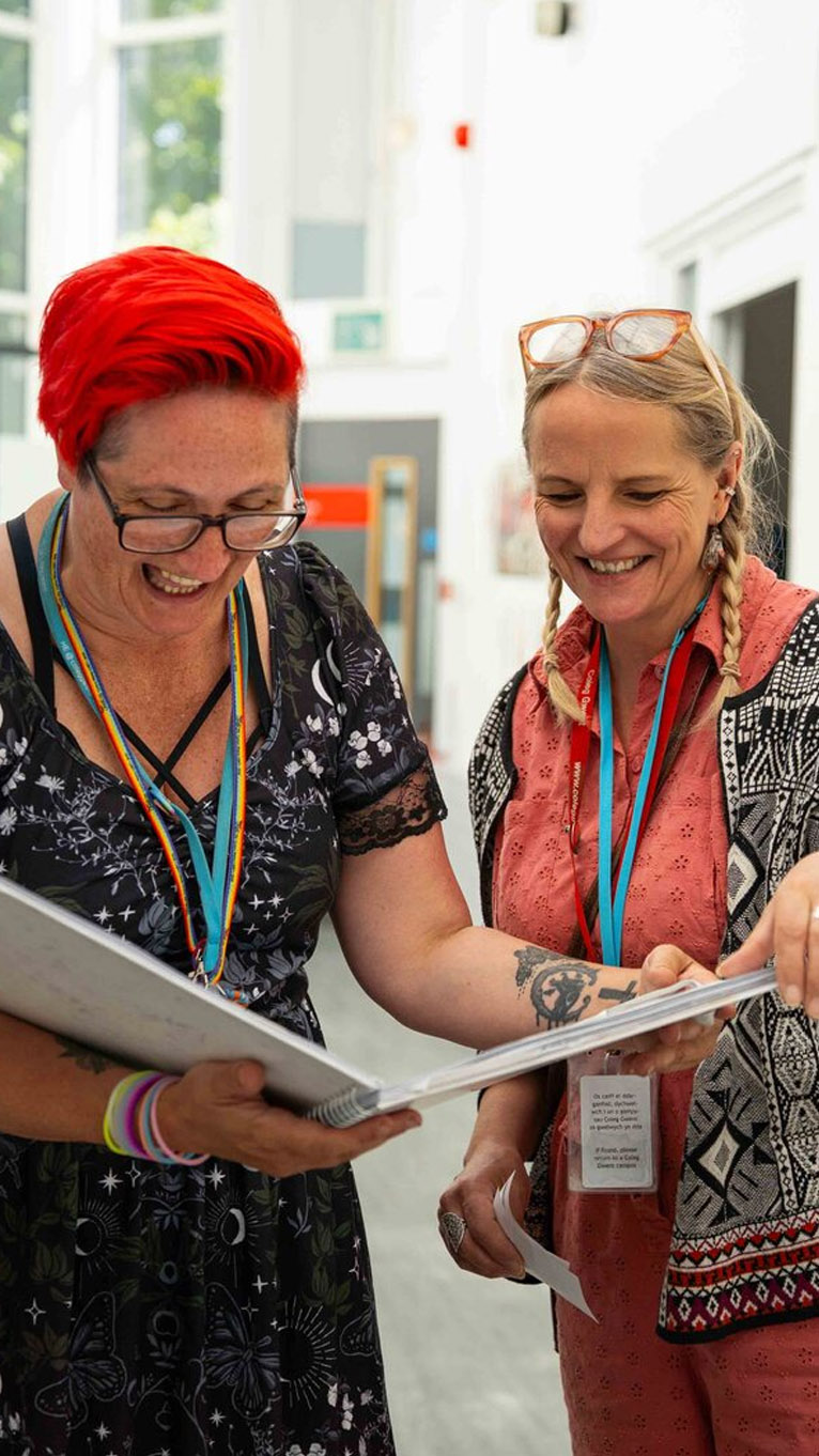 Staff in corridor looking at a folder